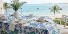 Load image into Gallery viewer, Blue and green watercolor botanical illustration on pure linen tablecloth with white dinnerware by the sea, Singapore art.